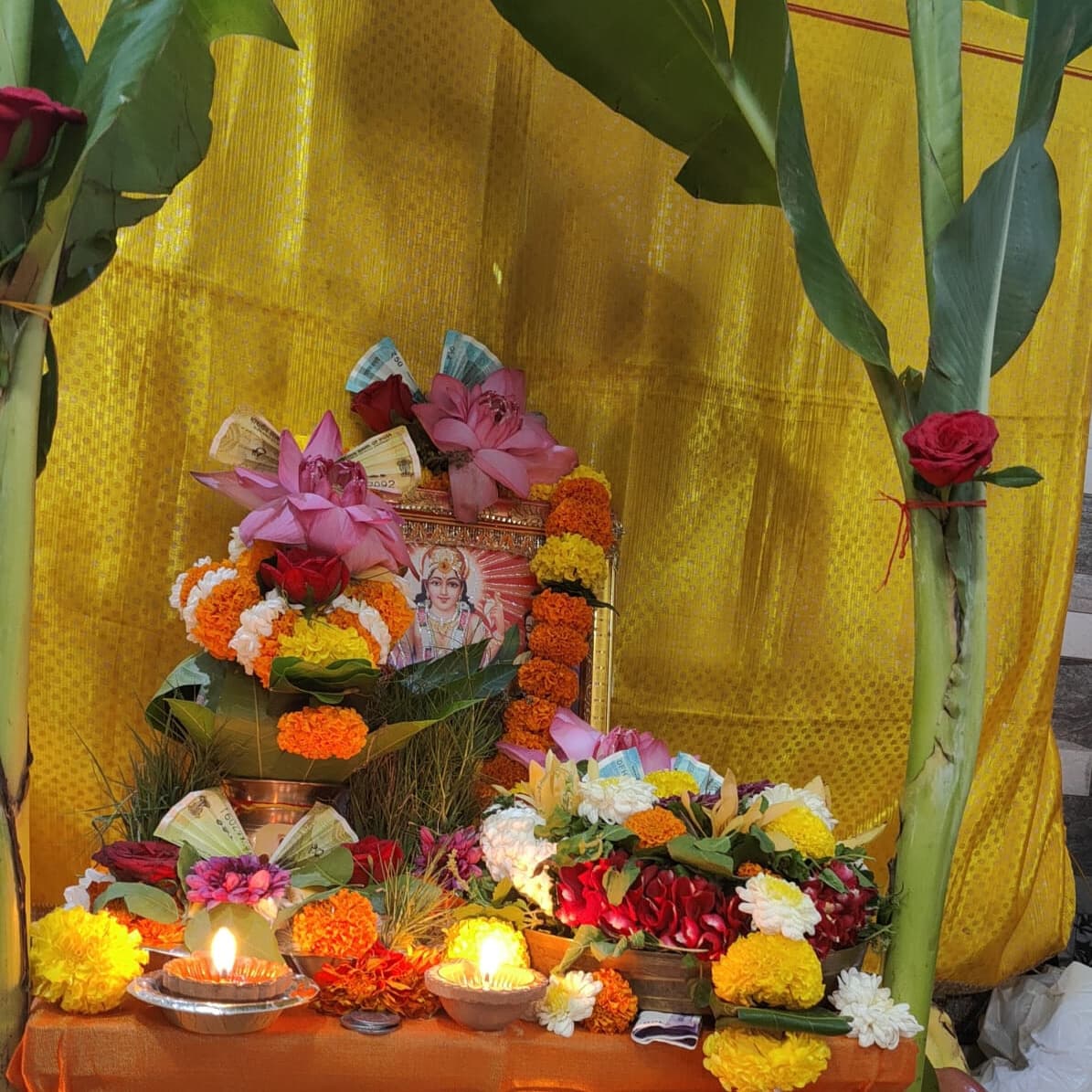 Ekadashi Vishnu puja with tulsi leaves, flowers and a ghee diya